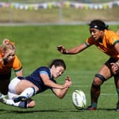 Scotland's Caity Mattinson (C) loses the ball during the New Zealand 2021 Women's Rugby World Cup Pool A match between Scotland and Australia.