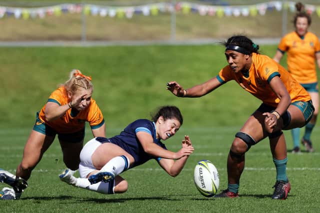 Scotland's Caity Mattinson (C) loses the ball during the New Zealand 2021 Women's Rugby World Cup Pool A match between Scotland and Australia.