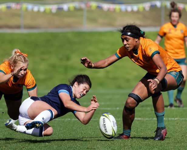 Scotland's Caity Mattinson (C) loses the ball during the New Zealand 2021 Women's Rugby World Cup Pool A match between Scotland and Australia.