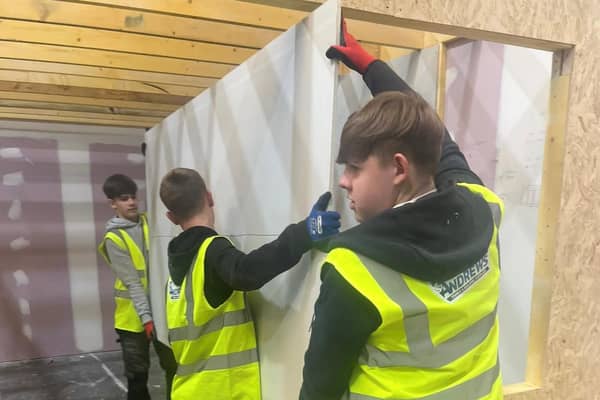 Senior pupils from Castlebrae Community Campus are helping with the construction of the test home at the Energy Training Academy in Dalkeith.