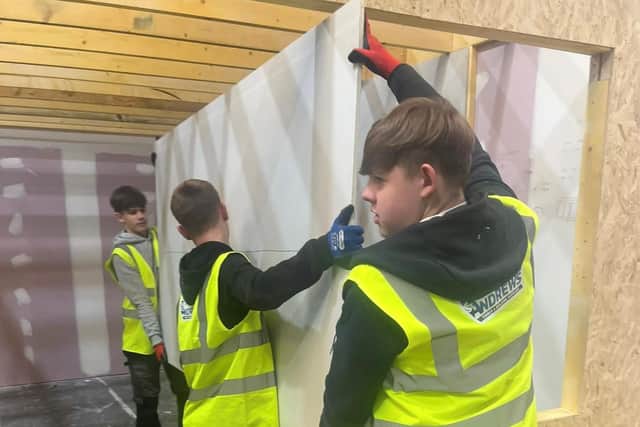 Senior pupils from Castlebrae Community Campus are helping with the construction of the test home at the Energy Training Academy in Dalkeith.