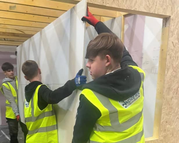 Senior pupils from Castlebrae Community Campus are helping with the construction of the test home at the Energy Training Academy in Dalkeith.