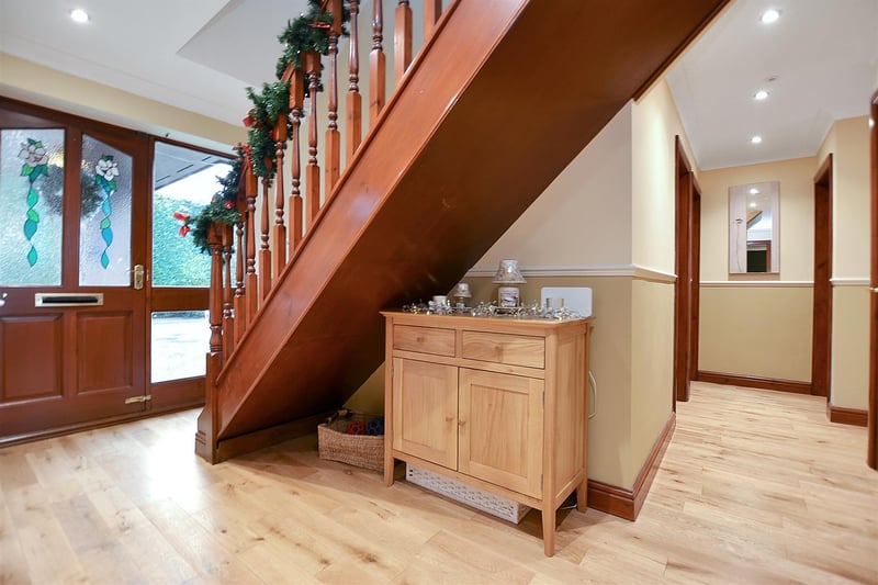 An L-shaped entrance hall, with solid oak floor.