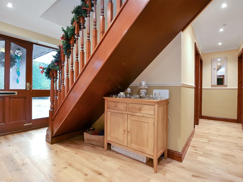 An L-shaped entrance hall, with solid oak floor.