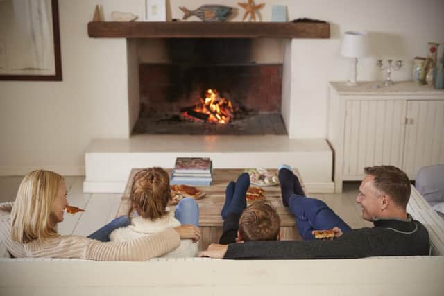 Family Sitting in front of an open Fire