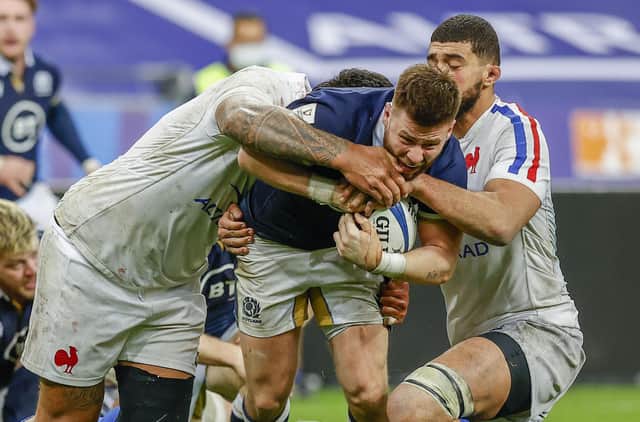 Scotland's Ali Price is tackeld by Swan Rebbadj during a Guinness Six Nations match between France and Scotland at the Stade de France, on March 26, 2021, in Paris, France.