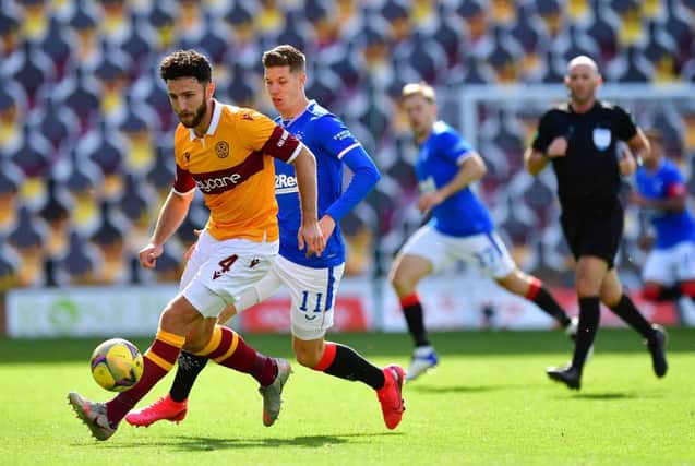 Motherwell defender Ricki Lamie holds off a challenge from Rangers striker Cedric Itten at Fir Park on Sunday (Photo by Mark Runnacles/Getty Images)