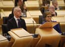 Scotland's Deputy First Minister and temporary Cabinet Secretary for Finance and Economy, John Swinney MSP, sat next to First Minister of Scotland Nicola Sturgeon, as he delivers the Scottish Budget to the Scottish Parliament in Edinburgh.