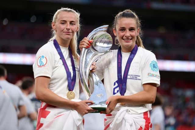 England's goalscorers Chloe Kelly and Ella Toone pose with the European Championship trophy after the 2-1 victory over Germany in the 2022 final at Wembley. (Photo by Naomi Baker/Getty Images)