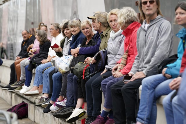 Members of the public in Whitehall, central London, ahead of the ceremonial procession of the coffin of Queen Elizabeth II from Buckingham Palace to Westminster Hall, London. Picture date: Wednesday September 14, 2022.