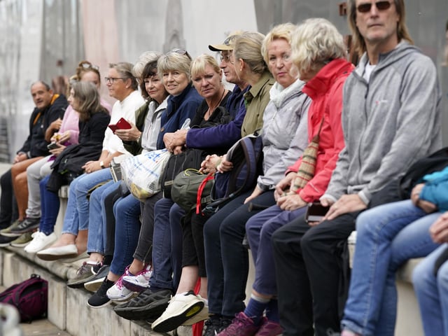 Members of the public in Whitehall, central London, ahead of the ceremonial procession of the coffin of Queen Elizabeth II from Buckingham Palace to Westminster Hall, London. Picture date: Wednesday September 14, 2022.