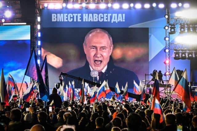 Russian President Vladimir Putin is seen on a giant screen at Red Square as he addresses a rally in 2022 (Picture: Alexander NEMENOV/AFP)