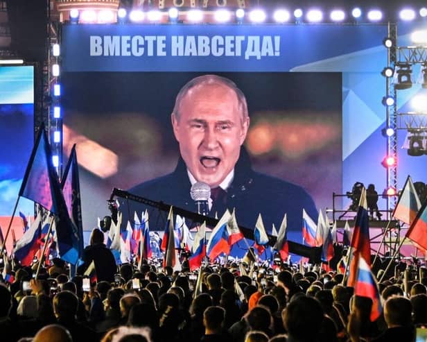 Russian President Vladimir Putin is seen on a giant screen at Red Square as he addresses a rally in 2022 (Picture: Alexander NEMENOV/AFP)
