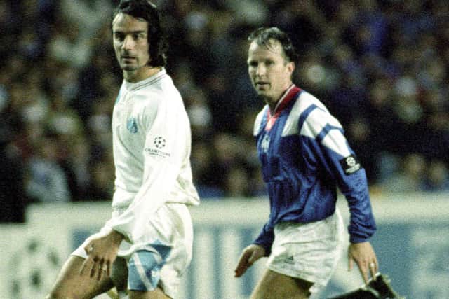 Marseille's Eric Di Meco (left) is pursued by Rangers midfielder Trevor Steven during a Champions League group fixture at Ibrox in 1992.