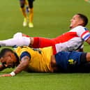 Rangers' English defender James Tavernier and Saint-Gilloise's French-Malagasy forward Loic Lapoussin fall during the UEFA Champions League third qualifying round first leg  match between Rangers and Royale Union Saint-Gilloise at the "Den Dreef Stadium" in Heverlee.  (Photo by LAURIE DIEFFEMBACQ/BELGA/AFP via Getty Images)
