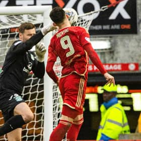 Aberdeen's Bojan Miovski collides with Hibs' David Marshall - and Neil Warnock believes a penalty should have been awarded.