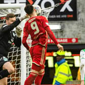 Aberdeen's Bojan Miovski collides with Hibs' David Marshall - and Neil Warnock believes a penalty should have been awarded.