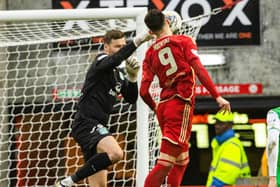 Aberdeen's Bojan Miovski collides with Hibs' David Marshall - and Neil Warnock believes a penalty should have been awarded.