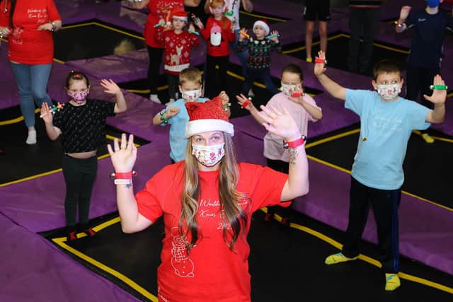 Lauren Sinclair, founder of the Worldwide Santa's Christmas Eve Jingle Facebook page, rehearses some bell ringing moves with friends and family at Sky High Trampoline Centre in Bankside Industrial Estate