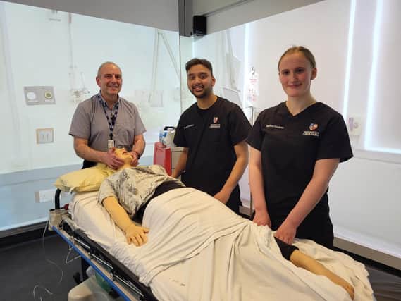 Medical Director Nick Fluck with students Rafsan and Alys