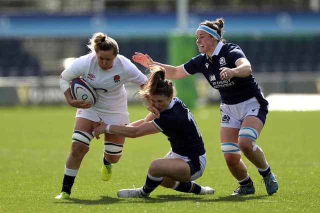 England's Marlie Packer attempts to brush off the tackle from Scotland's Helen Nelson (centre) and Rachel Malcolm (right) during the Women's Six Nations match at Castle Park, Doncaster. Picture: Bradley Collyer/PA