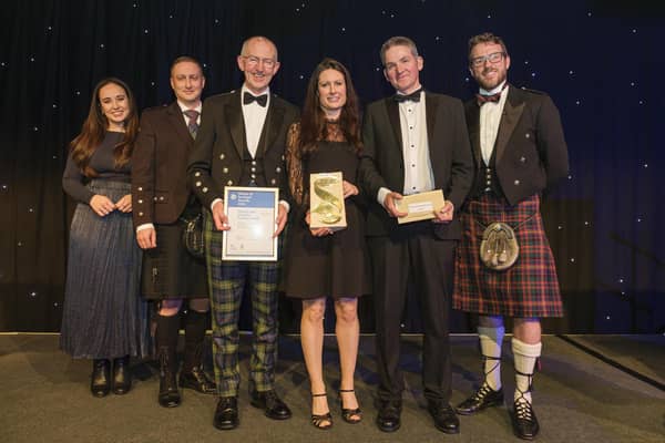 Collecting the award: Dr Lorraine Hawkins, River Director (centre) On her left is Chair of the River Dee Trust - Sandy Bremner and on her is Edwin Third, River Operations Manager (Pic: Mike Wilkinson)
