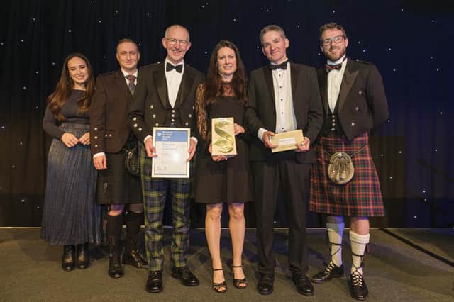 Collecting the award: Dr Lorraine Hawkins, River Director (centre) On her left is Chair of the River Dee Trust - Sandy Bremner and on her is Edwin Third, River Operations Manager (Pic: Mike Wilkinson)