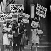 Demonstrators picket in front of a school board office protesting against segregation of students (Picture: National Archive/Newsmakers/Hulton Archive via Getty Images)