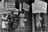 Demonstrators picket in front of a school board office protesting against segregation of students (Picture: National Archive/Newsmakers/Hulton Archive via Getty Images)