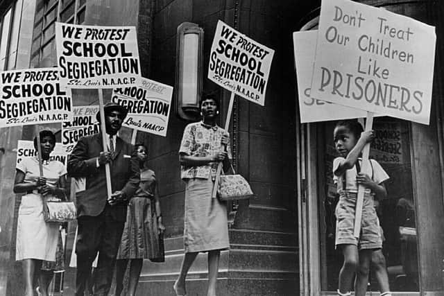 Demonstrators picket in front of a school board office protesting against segregation of students (Picture: National Archive/Newsmakers/Hulton Archive via Getty Images)