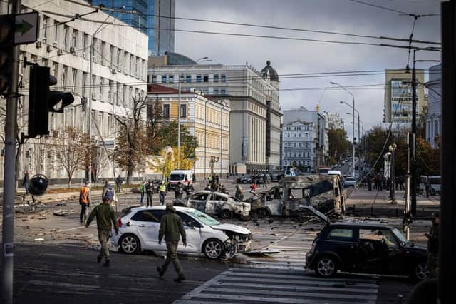 Emergency service personnel attend to the site of a blast in Kyiv.