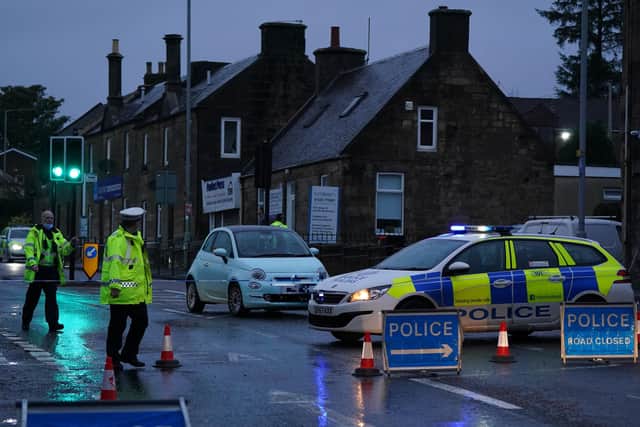 Police at the scene of a car crash on James Street in Carluke, South Lanarkshire. Three children and a woman have been taken to hospital after the crash which happened on Wednesday afternoon.