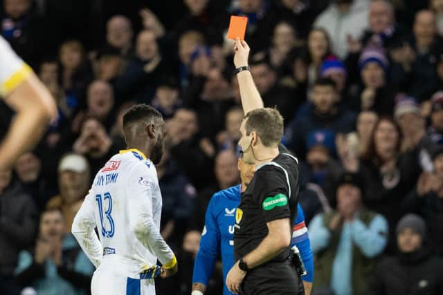 Referee Alan Muir shows St Johnstone's Diallang Jaiyesimi a red card following a VAR check. (Photo by Alan Harvey / SNS Group)