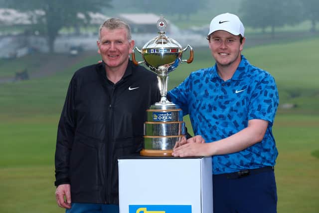 Bob MacIntyre poses with the trophy alongside his caddie and father Dougie MacIntyre after winning the RBC Canadian Open at Hamilton Golf & Country Club. (Photo by Vaughn Ridley/Getty Images)