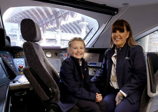 LNER driver Becky Brown and her daughter Maisie in a train cab. PIcture: Nigel Roddis/PA Wire