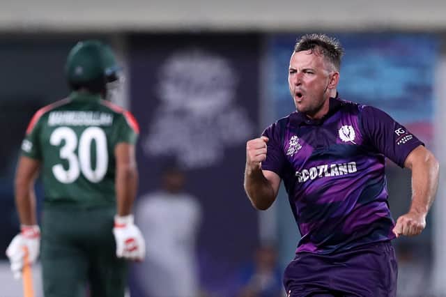 Scotland's Chris Greaves celebrates after taking the wicket of Bangladesh's Mushfiqur Rahim during the ICC mens T20 World Cup cricket match in Muscat, Oman (Photo by HAITHAM AL-SHUKAIRI/AFP via Getty Images)