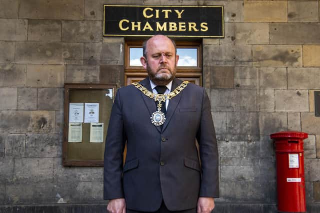 PIC LISA FERGUSON: Lord Provost Frank Ross observes the minute solence outside Edinburgh City Chambers