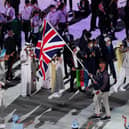 A British delegation of just 22, including flag bearers Hannah Mills and Mohamed Sbihi, has marched at the opening ceremony for the Tokyo Olympics.