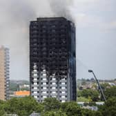 Smoke rises from the building after a huge fire engulfed the 24 storey residential Grenfell Tower block in Latimer Road, West London in the early hours of this morning on June 14, 2017.