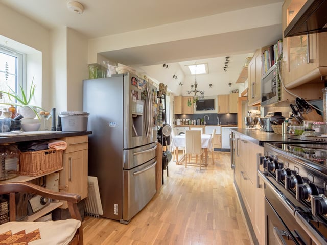 The kitchen has plenty of working space for culinary creations, with a large range cooker and generous storage options