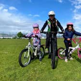 Deeside Thistle Cycling Club youth coach with two of the children attending the sessions