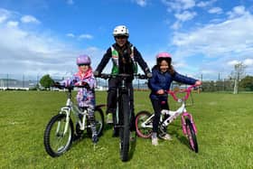Deeside Thistle Cycling Club youth coach with two of the children attending the sessions