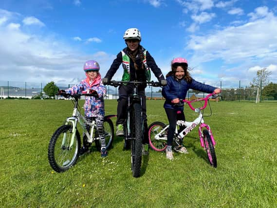 Deeside Thistle Cycling Club youth coach with two of the children attending the sessions