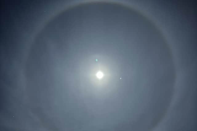 Photo of a halo around the moon above houses in Staffordshire (Pic: Ben Light/PA Wire)