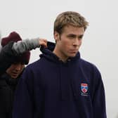 Actor Ed McVey, who plays the part of Prince William, on set in between filming scenes at the harbour for the next season of The Crown in St Andrews