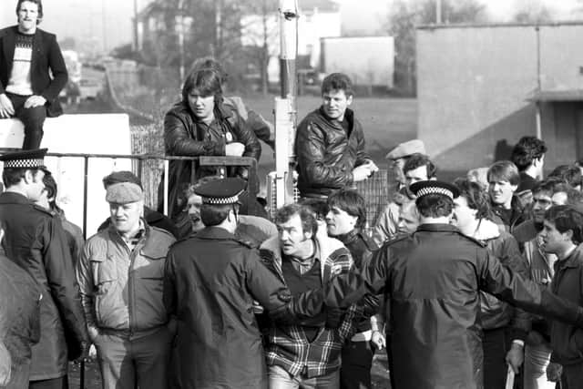 A picketer gets his head between two policeman to shout at a fellow miner outside Bilston Glen colliery during the industrial action of March 1984.