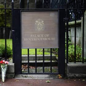 Flowers are laid at the Palace of Holyroodhouse following the death of the Queen