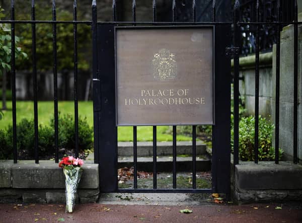 Flowers are laid at the Palace of Holyroodhouse following the death of the Queen