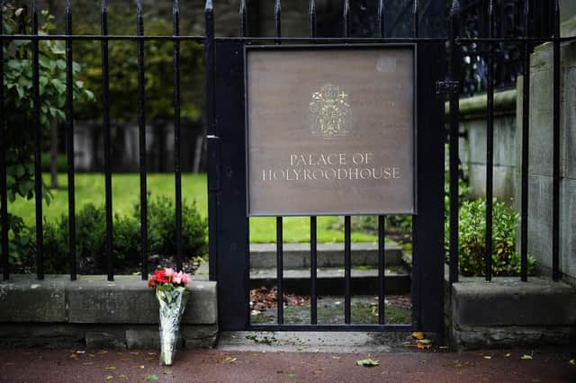 Flowers are laid at the Palace of Holyroodhouse following the death of the Queen