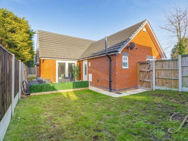 The gardens at the front and back of the bungalow are enclosed. They feature a low-maintenance lawn and patio area.